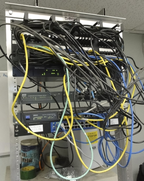 Relay rack with old switches and patch cords Photo of relay rack with old switches and jumble of patch cords.